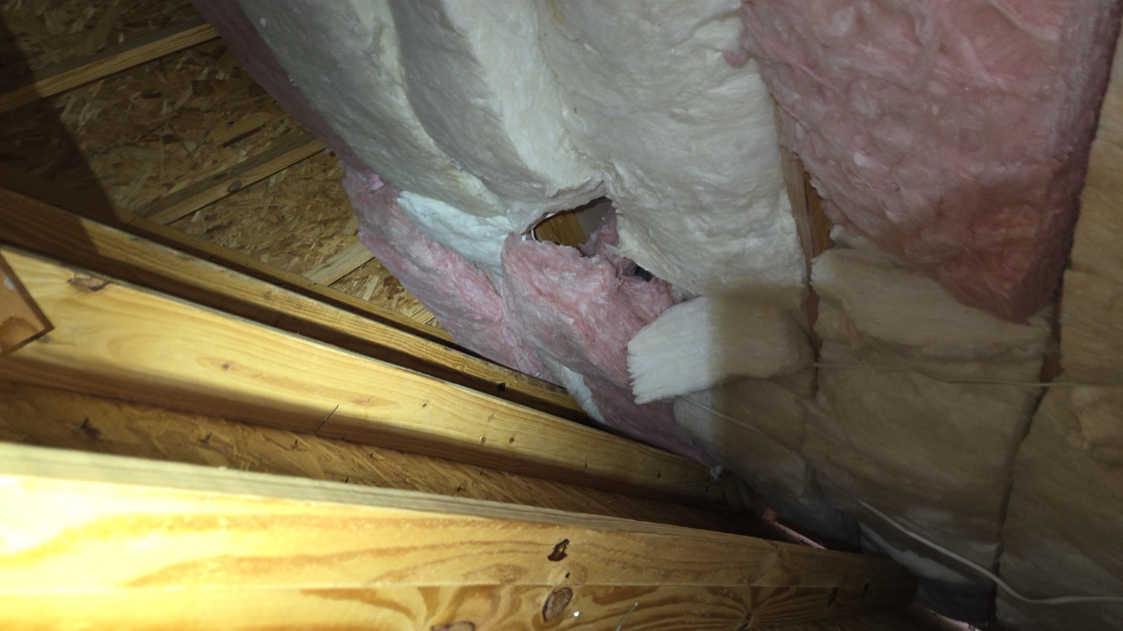Insulation batts in the west master vaulted ceiling